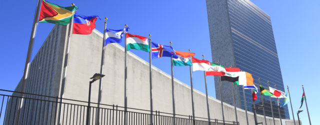 International flags fly in the wine in front of the the United Nations headquarters in New York City.