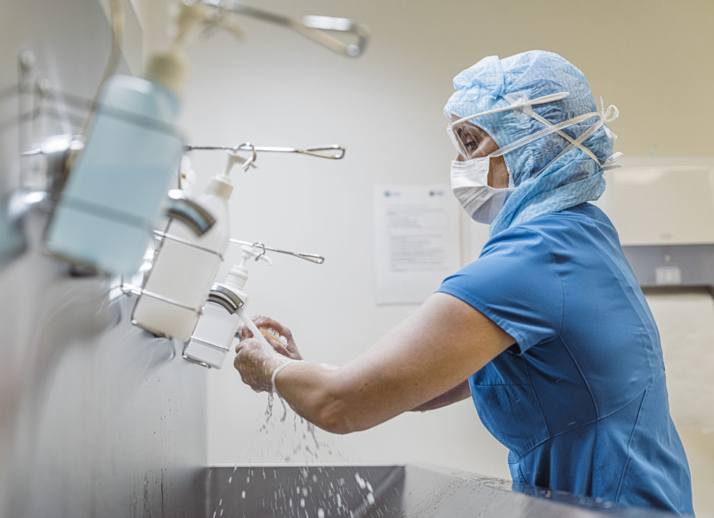 Nurse washing her hands hygiene to prevent Coronavirus infection.